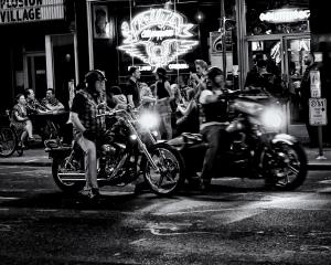 Black and white photograph showing two men on motorcycles outside Kelly's Olympian, a bar in downtown Portland Oregon.